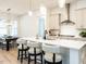 Open concept, eat-in kitchen with a modern center island, stainless steel appliances, and bar stool seating at 696 The Parks Dr, Pittsboro, NC 27312