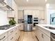 Spacious kitchen featuring stainless steel appliances, light wood floors, and ample cabinet space at 696 The Parks Dr, Pittsboro, NC 27312