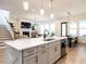 Open-concept kitchen with a large island, stainless steel appliances, and a view of the living area at 696 The Parks Dr, Pittsboro, NC 27312