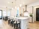 Bright kitchen with a large island, stainless steel appliances, and dining area with stylish pendant lighting at 696 The Parks Dr, Pittsboro, NC 27312