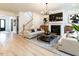 Bright and airy living room featuring modern decor, a fireplace, and beautiful hardwood floors at 696 The Parks Dr, Pittsboro, NC 27312