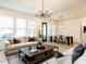 Open living area with a spacious layout, great lighting and view to kitchen and dining room at 696 The Parks Dr, Pittsboro, NC 27312