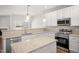 Bright kitchen features white cabinetry, granite countertops, stainless appliances, and decorative pendant lighting at 711 Keystone Park Dr # 51, Morrisville, NC 27560