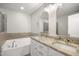 Bright bathroom featuring a soaking tub, double vanity, and granite countertops at 711 Keystone Park Dr # 51, Morrisville, NC 27560
