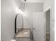 Bathroom features granite counters, arched mirror, vanity, lighting, and an open door at 711 Keystone Park Dr # 51, Morrisville, NC 27560