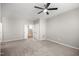 Neutral bedroom features a ceiling fan, closet, and leads to the stairs at 711 Keystone Park Dr # 51, Morrisville, NC 27560
