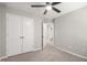 Neutral bedroom features a ceiling fan, closet, and leads into an en-suite bathroom at 711 Keystone Park Dr # 51, Morrisville, NC 27560