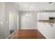 Open dining area with hardwood floors, modern chandelier, breakfast bar and slider door to the deck at 711 Keystone Park Dr # 51, Morrisville, NC 27560