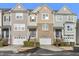 Charming townhome featuring varied siding and brick accents, with a one-car garage and tidy landscaping at 711 Keystone Park Dr # 51, Morrisville, NC 27560
