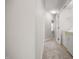 Hallway featuring neutral carpet and gray paint with a laundry closet at the end at 711 Keystone Park Dr # 51, Morrisville, NC 27560