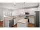 Modern kitchen with pendant lights, stainless steel appliances, white cabinets and a breakfast bar at 711 Keystone Park Dr # 51, Morrisville, NC 27560