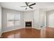 Cozy living room with hardwood floors, a fireplace, window and slider door offering natural light at 711 Keystone Park Dr # 51, Morrisville, NC 27560