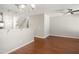 Open-concept living space showcasing hardwood floors, a ceiling fan, and seamless transition to the kitchen at 711 Keystone Park Dr # 51, Morrisville, NC 27560