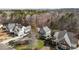 Aerial view of a neighborhood showcasing well-maintained homes, mature trees, and lush green lawns at 818 Cabin Creek, Pittsboro, NC 27312