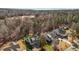 An aerial perspective highlights a neighborhood's well-maintained homes, surrounded by dense, mature trees and landscaping at 818 Cabin Creek, Pittsboro, NC 27312