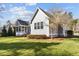 View of the side and rear exterior of the home, lawn, and landscaped beds at 818 Cabin Creek, Pittsboro, NC 27312