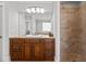 A well-lit bathroom features a dual-sink vanity, a neutral color scheme, and a glass-enclosed shower at 818 Cabin Creek, Pittsboro, NC 27312