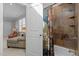 Bathroom with a neutral tile shower, tub, and colorful floral print shower curtain at 818 Cabin Creek, Pittsboro, NC 27312