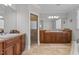 Bathroom with a tiled floor, granite countertops, and wooden cabinetry surrounding a glass shower stall at 818 Cabin Creek, Pittsboro, NC 27312