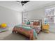 Bright bedroom with a colorful bedspread and ample natural light from the windows at 818 Cabin Creek, Pittsboro, NC 27312