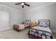 Bright bedroom featuring two twin beds with wrought iron frames and neutral color walls at 818 Cabin Creek, Pittsboro, NC 27312