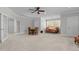 Large bonus room with dining area, sitting area, plush carpeting, and ceiling fan at 818 Cabin Creek, Pittsboro, NC 27312