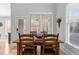 Cozy dining area with natural light, wood table and seating near the door and windows at 818 Cabin Creek, Pittsboro, NC 27312