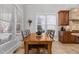 Bright dining area with a wooden table set and views of the exterior through the window at 818 Cabin Creek, Pittsboro, NC 27312