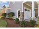 Charming home exterior with stone accents, manicured landscaping, and an attached garage at 818 Cabin Creek, Pittsboro, NC 27312
