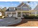 Beautiful two-story home with a welcoming front porch, well-maintained lawn, and a spacious driveway at 818 Cabin Creek, Pittsboro, NC 27312