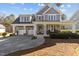 Beautiful two-story home with a welcoming front porch, well-maintained lawn, and a spacious driveway at 818 Cabin Creek, Pittsboro, NC 27312