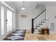 Bright foyer with a staircase and decorative rug creates a welcoming entrance at 818 Cabin Creek, Pittsboro, NC 27312
