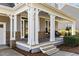 Inviting front porch with classic columns, stone accents, and ample seating area at 818 Cabin Creek, Pittsboro, NC 27312