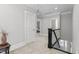 Light-filled upper hallway with neutral carpeting, white trim, and access to bedrooms with decorative railings at 818 Cabin Creek, Pittsboro, NC 27312