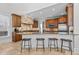 Open kitchen with an island, bar stool seating, granite counters, and stainless steel appliances at 818 Cabin Creek, Pittsboro, NC 27312
