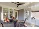 Screened porch with tiled floors, ceiling fan, and comfortable seating, perfect for outdoor relaxation at 818 Cabin Creek, Pittsboro, NC 27312