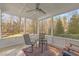 Sunroom with tiled floors, outdoor seating, and a view of the treed backyard at 818 Cabin Creek, Pittsboro, NC 27312