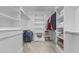 Spacious walk-in closet with built-in shelving, hanging racks, and neutral carpeting, perfect for organized storage at 818 Cabin Creek, Pittsboro, NC 27312