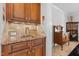Wet bar with granite countertop, wooden cabinets, and a convenient sink at 818 Cabin Creek, Pittsboro, NC 27312