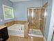 Bathroom with bathtub and glass shower at 905 Maynard Creek Ct, Cary, NC 27513