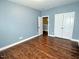 Bedroom featuring stylish laminate floors, base trim, double closets, and neutral walls at 905 Maynard Creek Ct, Cary, NC 27513