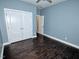 Bedroom with hardwood flooring, closet, and a pale blue painted wall at 905 Maynard Creek Ct, Cary, NC 27513