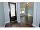 Bright entryway featuring a decorative front door, hardwood floors, and an open view to an adjacent room at 905 Maynard Creek Ct, Cary, NC 27513