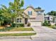 Charming two-story home featuring stone accents, a well-manicured lawn, and an attached two-car garage at 905 Maynard Creek Ct, Cary, NC 27513