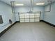 View of the empty attached garage with white door at 905 Maynard Creek Ct, Cary, NC 27513