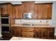 Modern kitchen featuring granite countertops, stainless steel appliances, and dark wood cabinetry at 905 Maynard Creek Ct, Cary, NC 27513