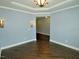 Cozy living room with hardwood floors, tray ceiling, decorative sconces and fresh paint at 905 Maynard Creek Ct, Cary, NC 27513