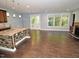 Open-concept living space featuring hardwood floors, a fireplace, and a kitchen island with bar seating at 905 Maynard Creek Ct, Cary, NC 27513