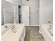 Bathroom featuring dual sinks and a tub with a shower at 1009 Bittbourg Ln, Wendell, NC 27591