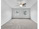 A bedroom with two windows and a ceiling fan, with gray walls and carpet at 1009 Bittbourg Ln, Wendell, NC 27591